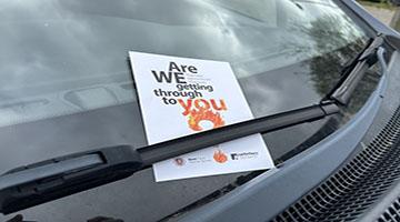 Fire safety leaflet under vehicle windscreen wiper