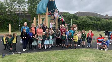 Children in front of play area equipment
