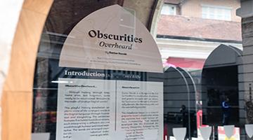 Display board behind glass wall